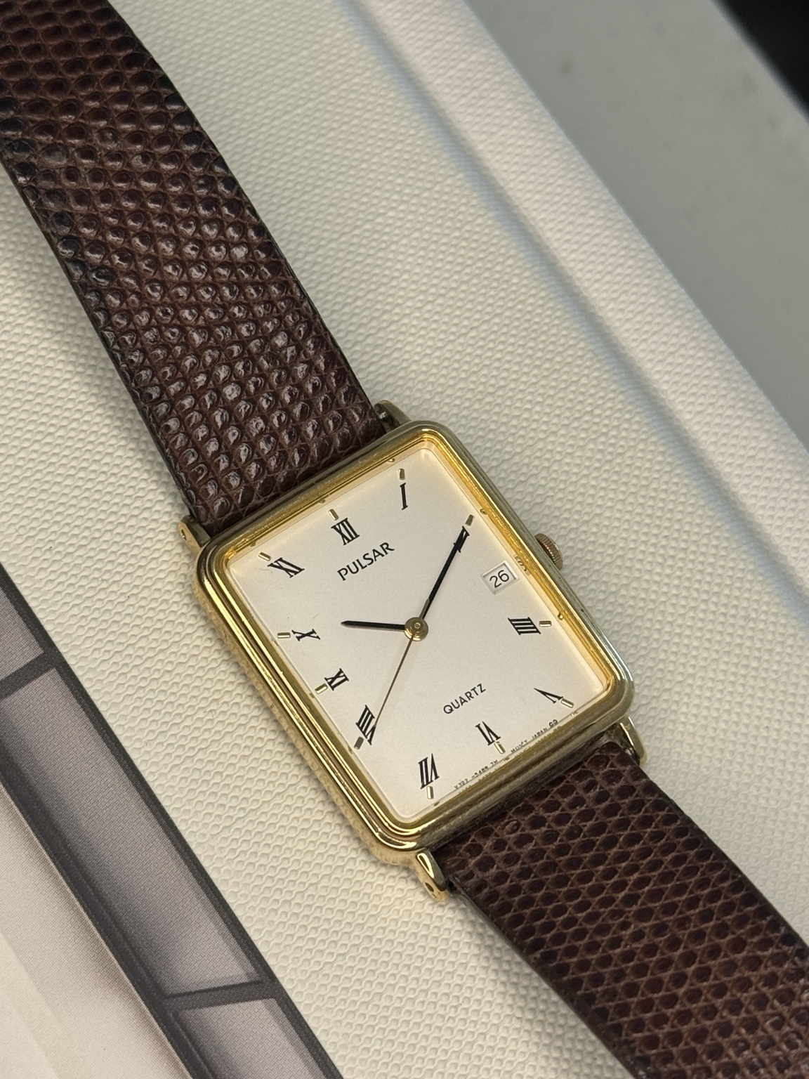 Original watch face and dial photograph of Pulsar Quartz Gold-Tone Rectangular Roman Numeral Date Watch